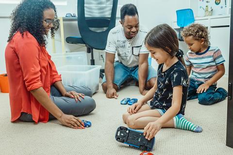 kids playing with cars image