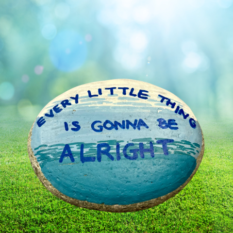 a rock painted like the shoreline with the words "every little thing is gonna be alright" written on it