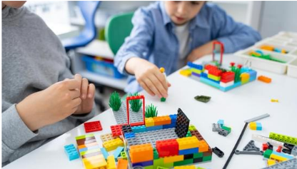 two children building with LEGO bricks