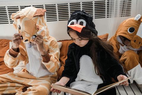 kids reading while wearing costumers
