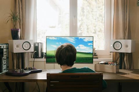 boy sitting at desktop computer screen