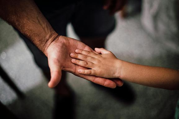 child's hand in adult hand
