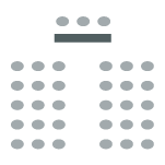 Chairs arranged in an audience formation with a presenter's table facing them. 